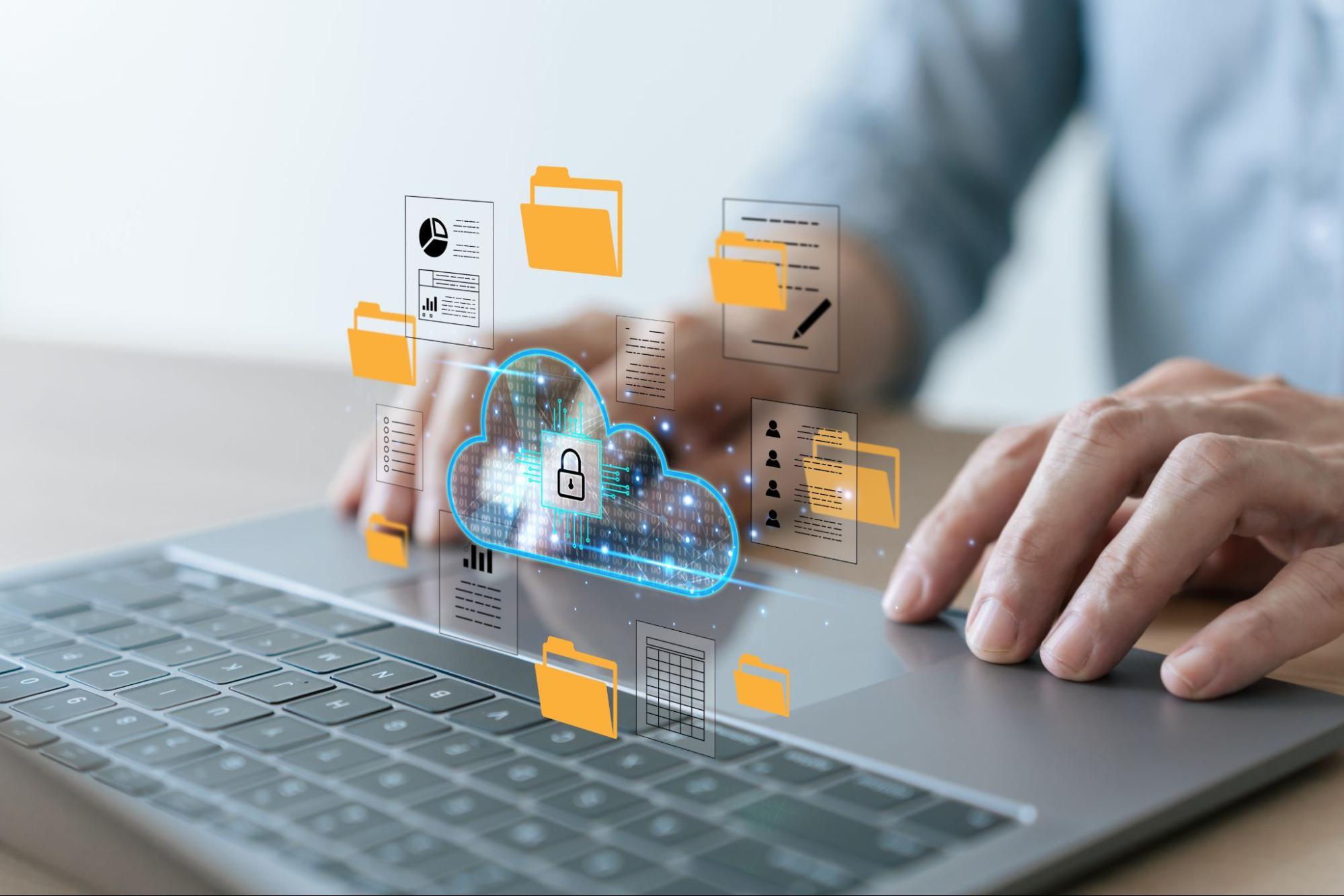 Hands using a laptop with a digital cloud security icon surrounded by floating document and folder graphics.
